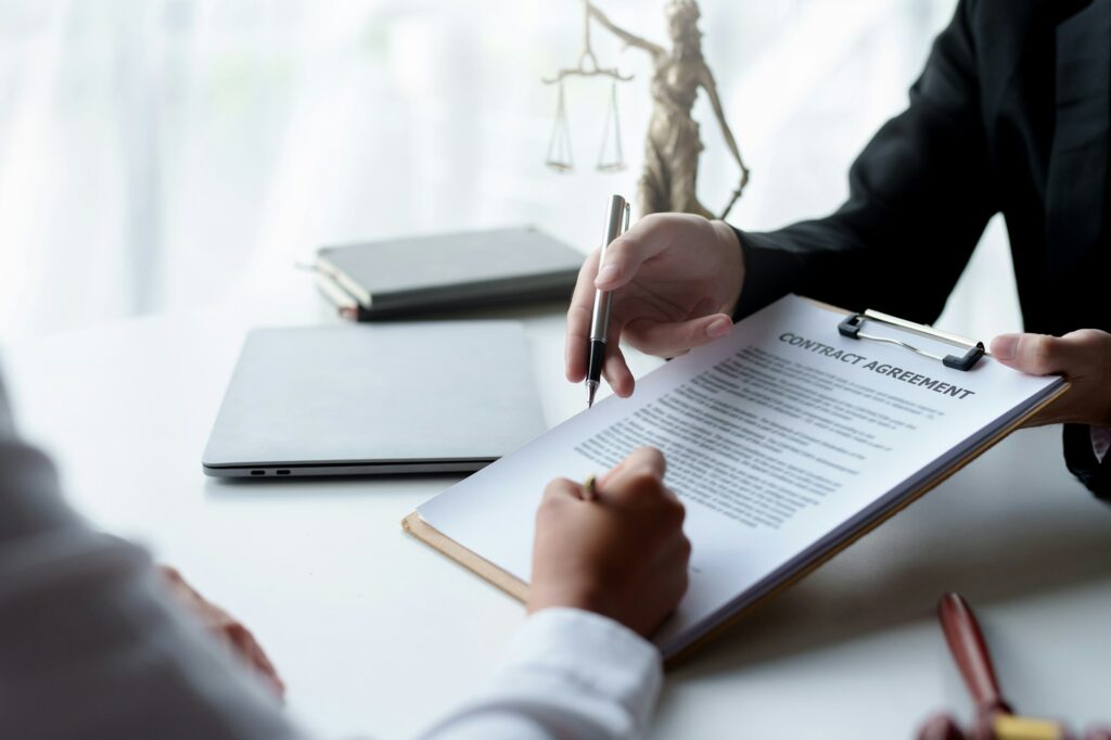 Businessman and lawyer discuss and advice on contract documents.